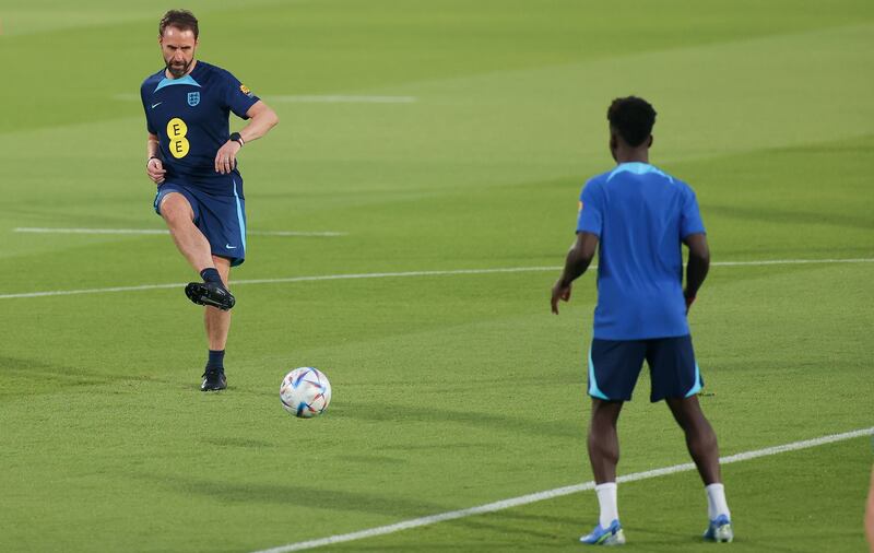 England manager Gareth Southgate passes tha ball to Bukayo Saka. EPA