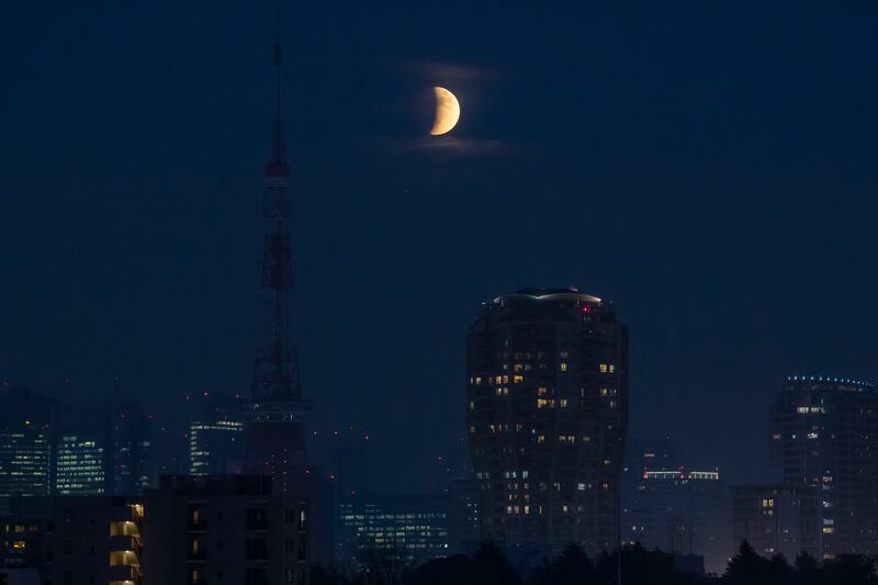 The partial lunar eclipse over Tokyo Tower in Japan. AP Photo