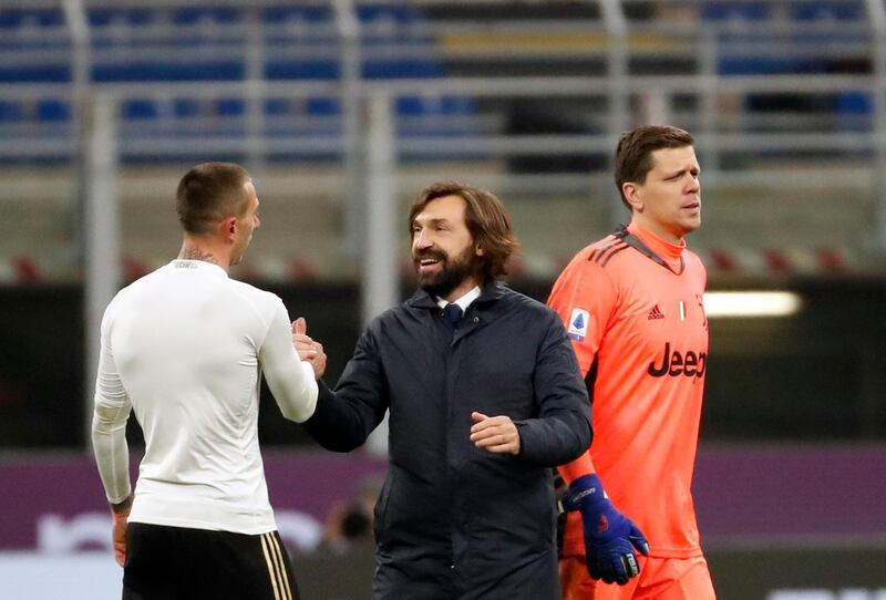 Juventus coach Andrea Pirlo, centre, shakes hands with Federico Bernardeschi. AP