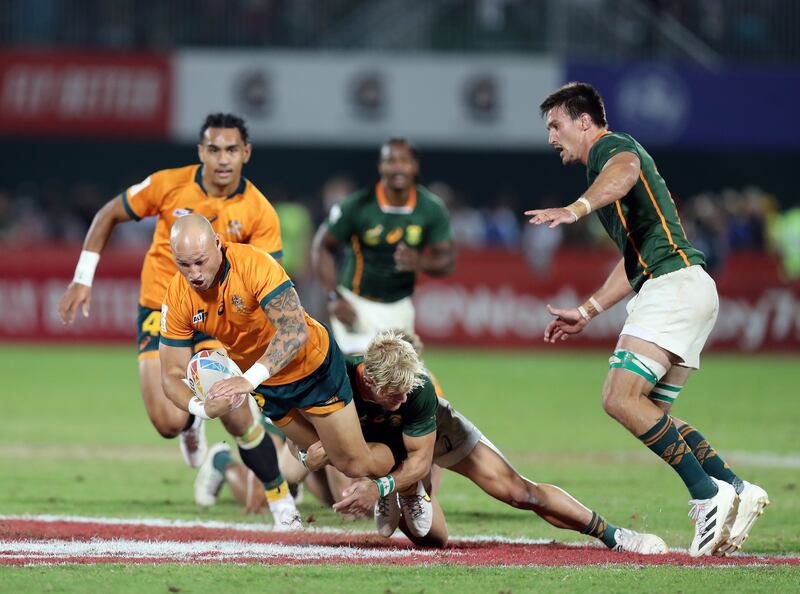 Australia's Bill Meakes is tackled during the Dubai Sevens final.