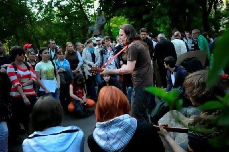 Activists gather around a musician at an anti-government protest camp in central Moscow earlier this month. Natalia Kolesnikova / AFP