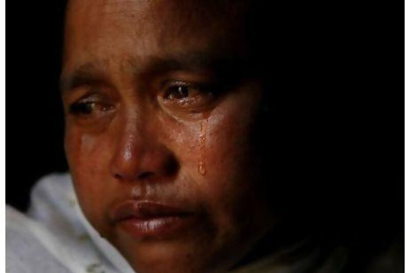 Bimola Khaidem, wife of police officer Khaidem Muhi who was killed by a homemade grenade hurled by a militant, cries at her home in Imphal, in the northeastern Indian state of Manipur.