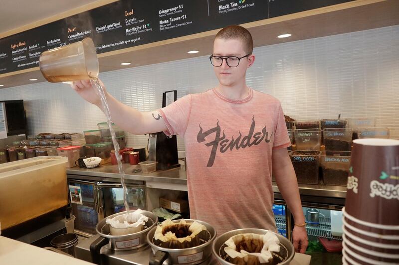 Adam Lange pours water while making coffee at a Philz Coffee shop in San Francisco, Friday, March 30, 2018. Coffee sellers will have to post ominous warnings in California because each cup contains a chemical linked to cancer, a judge ruled. The culprit is a byproduct of the bean roasting process that is a known carcinogen and has been at the heart of an eight-year legal struggle between a tiny nonprofit group and Big Coffee companies. (AP Photo/Jeff Chiu)