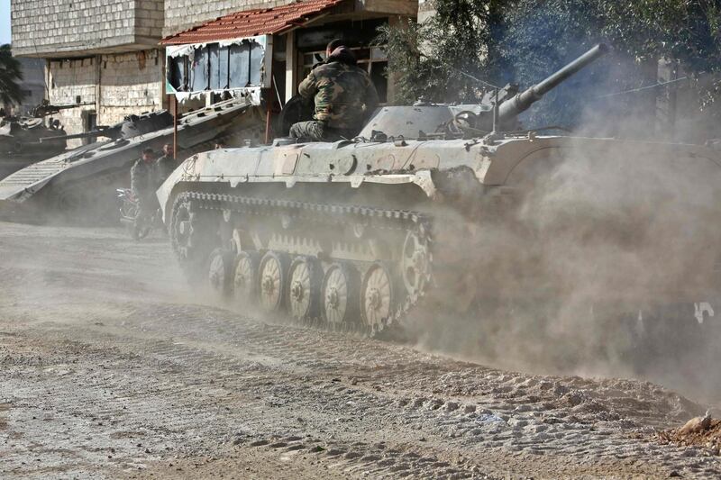A Syrian army APC rolls in the former rebel-held area of Beit Nayem in the Eastern Ghouta region on the outskirts of the capital Damascus on March 6, 2018. AFP