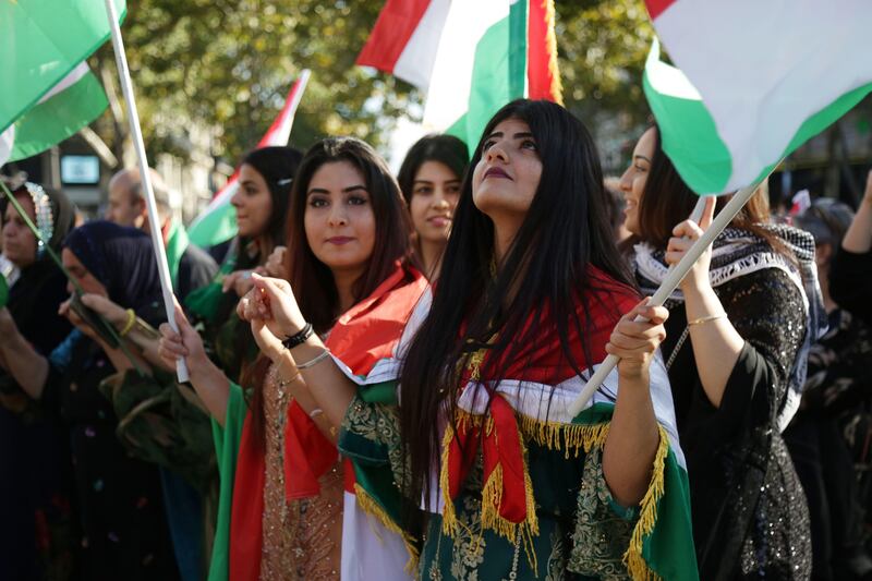 People wave Kurdish  on September 22, 2017, on the Place de la Republique in Paris, during a gathering in support of a "yes" vote ahead of an independence referendum for Iraqi Kurdistan due to be held on September 25.
Iraq's Kurds have faced mounting international pressure, including from neighbouring Iran and Turkey, to call off the referendum  that the UN Security Council has warned was potentially destabilising.
 / AFP PHOTO / Zakaria ABDELKAFI