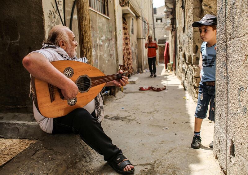 A musician performs traditional songs on an oud outside his house in the Rafah camp for Palestinian refugees in the southern Gaza Strip. AFP