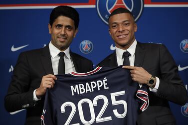 Paris Saint-Germain's president Nasser Al-Khelaifi (L) and Paris Saint Germain's forward Kylian Mbappe pose with a PSG jersey during a press conference at the Parc des Princes stadium in Paris, France, 23 May 2022.  Kylian Mbappe renewed his contract with French Ligue 1 soccer club Paris Saint-Germain until 2025.   EPA / Christophe Petit Tesson