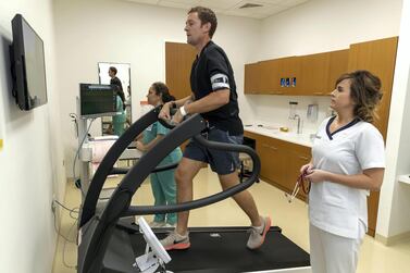Staff Nurse Aishling Finlay and Ana Gancinho, Cardiovascular Technician at Cleveland Clinic Abu Dhabi, perform a stress test on reporter Nick Webster by having him perform cardiovascular exercise to test his health. Antonie Robertson / The National