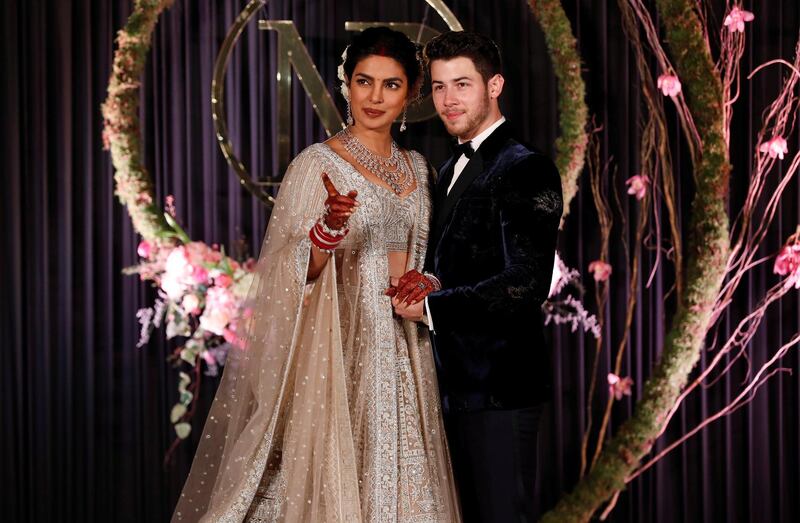 Newlyweds Priyanka Chopra, 36, and Nick Jonas, 26, pose for a photograph during a reception at a hotel in New Delhi on December 4, 2018. Photo: Reuters