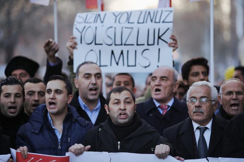Demonstrators protest against Turkey's ruling Justice and Development Party and demand the resignation of Prime Minister Tayyip Erdogan in Ankara on Saturday. The banner reads "Corruption is your way". Umit Bektas / Reuters