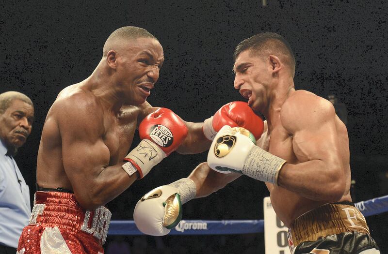 LAS VEGAS, NV-  DECEMBER 13:  Amir Khan (R) is hit by Devon Alexander during their welterweight bout at the MGM Grand Garden Arena on December 13, 2014 in Las Vegas, Nevada. Khan won with a 12-round unanimous decision. (Photo by Donald Miralle/Getty Images)