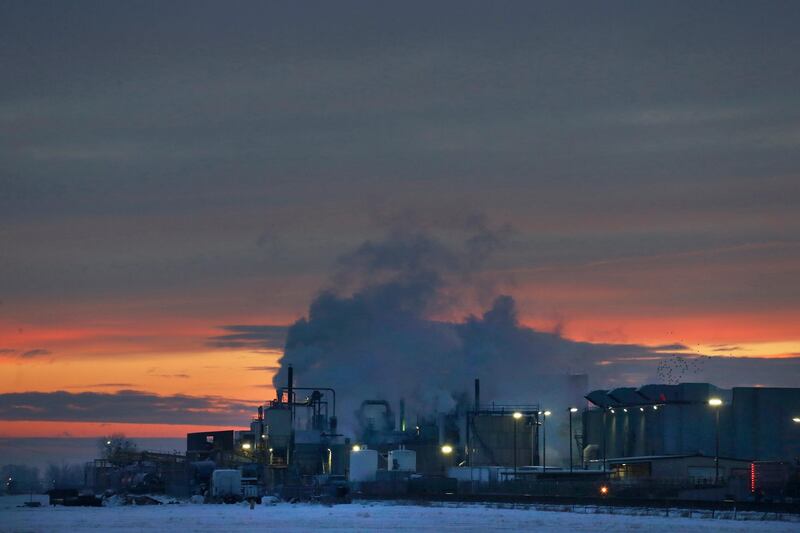 FILE - In this Jan. 11, 2016 file photo, dawn approaches over the meat processing plant owned and run by Cargill Meat Solutions, in Fort Morgan, a small town on the eastern plains of Colorado. The U.S. Equal Employment Commission said Friday, Sept. 14, 2018 that Cargill has agreed to pay $1.5 million to 138 Somali-American Muslim workers who were fired from the plant in 2016 after they were refused prayer breaks. (AP Photo/Brennan Linsley, File)
