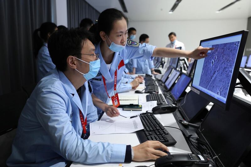 Technicians work at the Beijing Aerospace Control Center in Beijing May 15, 2021. Xinhua via AP