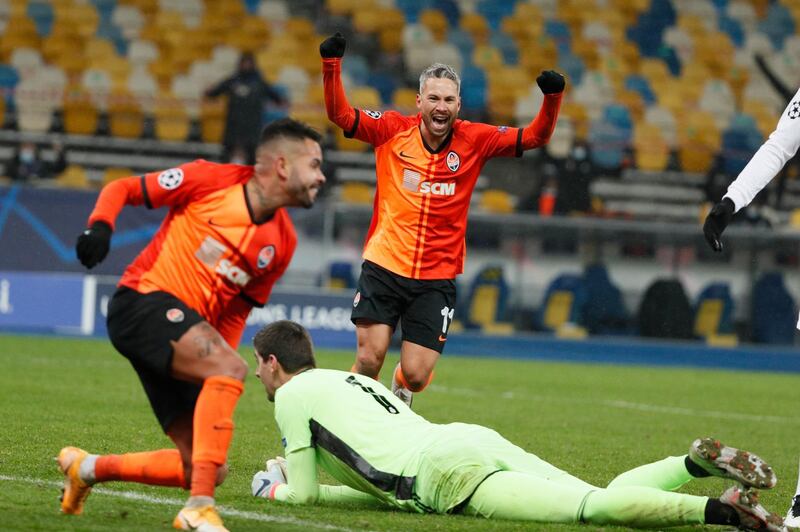 Real Madrid goalkeeper Thibaut Courtois lays on the ground as Shakhtar Donetsk's Marlos celebrates the first goal scored by Dentinho. Reuters