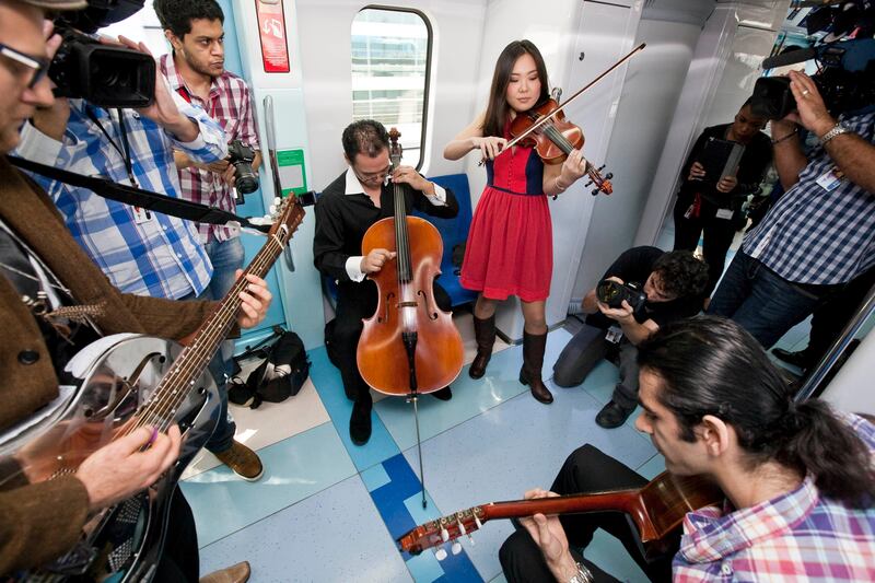 DUBAI, UNITED ARAB EMIRATES,  January 23, 2013. Tim Hassal (left with guitar) and Co perform during the Fashion Train show by Dubai Shopping Festival and Bloomingdales where a fashion show was held on the Dubai Metro. (ANTONIE ROBERTSON / The National)
