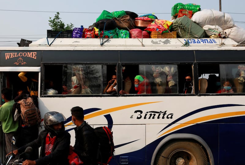 People head to their village in a crowded bus after Nepal declared restrictions effective from Thursday as the major second wave of the Covid-19 emerges in Kathmandu, Nepal. Reuters