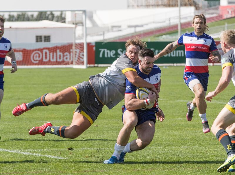 Dubai Hurricanes (grey/white shirts) take on Jebel Ali Dragons at The Sevens Stadium in Dubai. Ruel Pableo for The National