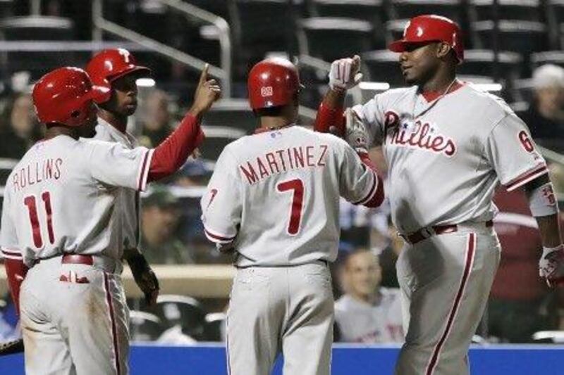 Philadelphia Phillies' Ryan Howard, right, celebrates with teammates Michael Martinez (7), Jimmy Rollins (11), and Juan Pierre (10). This scene hasn't happened a great many times this season, much to the dismay of Philadelphia.