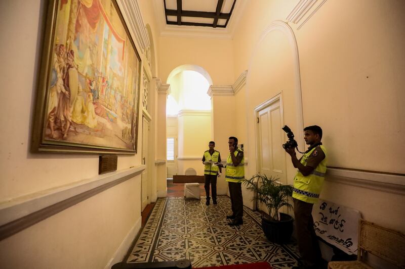 Officers inspect the palace for damage. EPA