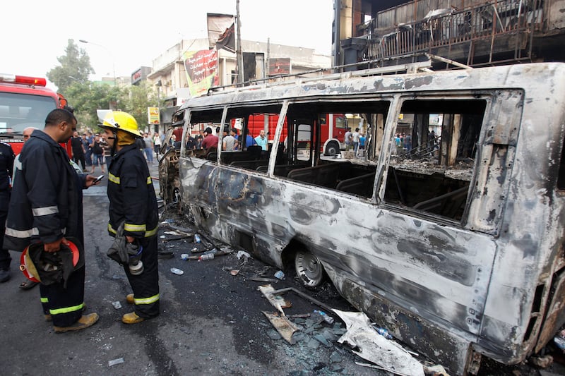 Firemen inspect the site of the suicide bomb in the Karrada shopping area.