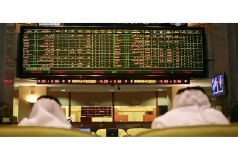 Traders monitor the stock market at the Abu Dhabi Securities Exchange.