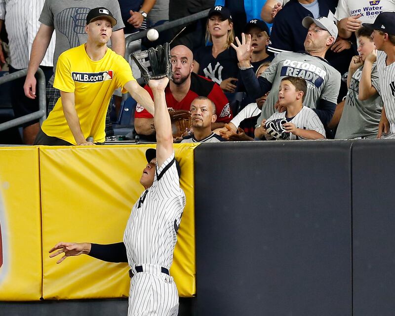 New York Yankees right fielder Aaron Judge makes a catch at the wall on a line drive hit by Cleveland Indians' Francisco Lindor during Game 3 of baseball's American League Division Series in New York. Kathy Willens / AP Photo