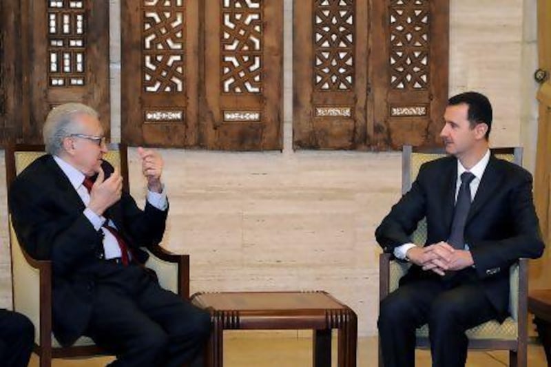Syrian president Bashar Al Assad, right, meets with international envoy to Syria Lakhdar Brahimi in Damascus yesterday. Mr Assad has been warned not to use chemical weapons.