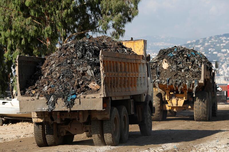 Trucks carry garbage to a new land reclamation site in Bourj Hammoud, east of Beirut, Lebanon. Hussein Malla / AP