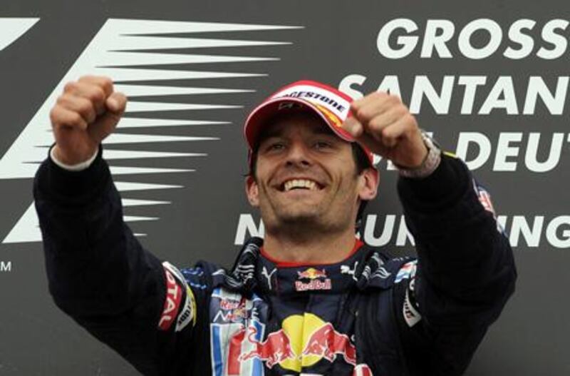 Mark Webber celebrates his maiden  win on the podium at the German Grand Prix at the Nurburgring.
