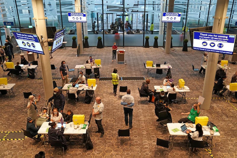 Staff at a vaccination centre in Wembley Stadium, London help administer Covid-19 booster shots. PA