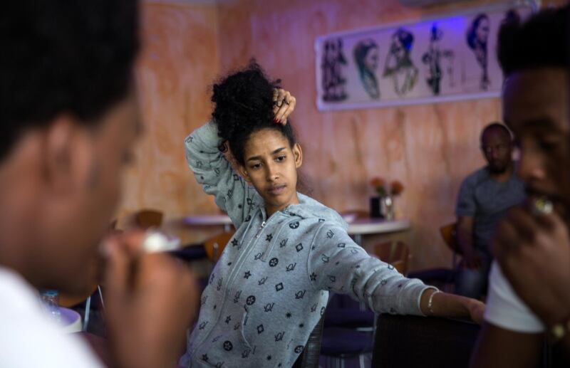 Fiori Taklit, a 25 year old single woman from Eritrea who who works at the Harhara café in south Tel Aviv , said: "Everyone is afraid. We can't go back to Eritrea and we can't go to Rwanda either. How can you sleep when all the time you are thinking about being expelled, wondering what you will do tomorrow and who will help you. If they throw me to Rwanda, what will I do?"Taklit, 25, received no response at all to her application for asylum in 2013, she said. She explained that she left Eritrea because she was a Pentecostalist Christian. Adherence to that faith is banned there, suppressed and sometimes punished with extensive detention.

Like the other Eritreans interviewed, she had harrowing memories of crossing Sinai en route to Israel. "Three of our group died on the way. We didn't have food, water, anything. I paid ten thousand dollars to the Beduin to take me. Friends of my parents helped with this."The Israeli government is trying to carry out a plan to expel over 38,000 African migrants currently living in Israel.(Photo by Heidi Levine for The National).
