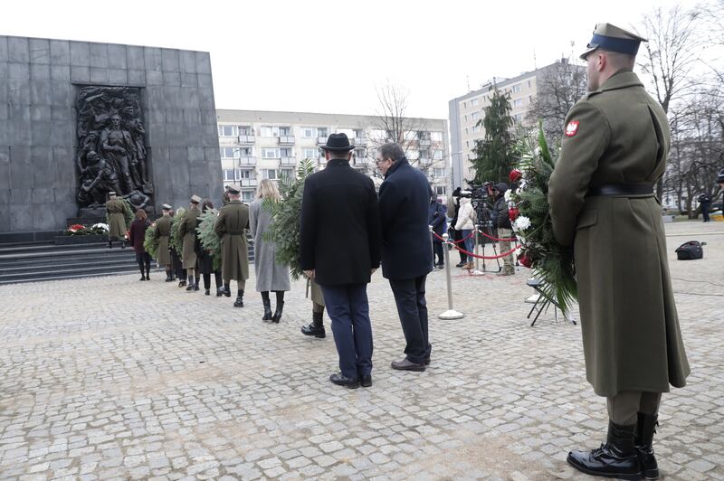 People line up to pay tribute at the Monument to the Ghetto Heroes in Warsaw, Poland. EPA