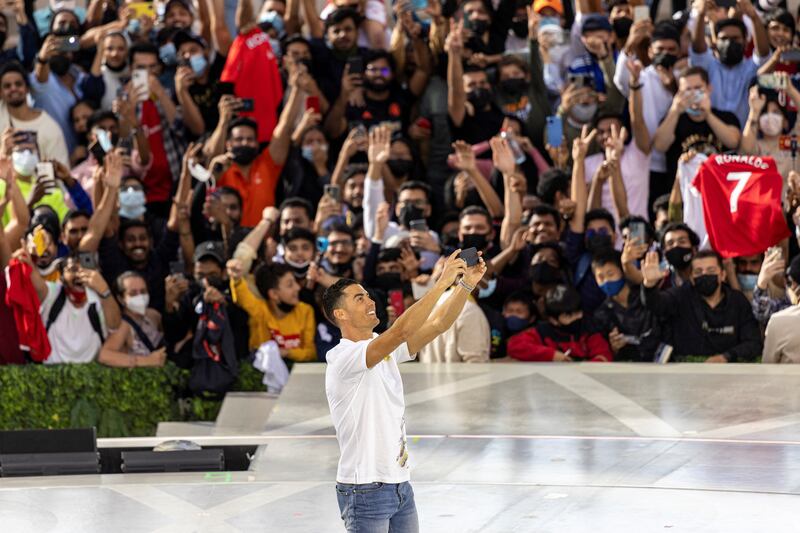 Cristiano Ronaldo, Manchester United forward footballer, takes a selfie with the crowd during Expo 2020 Dubai at Al Wasl Plaza, in Dubai on January 28, 2022. Reuters