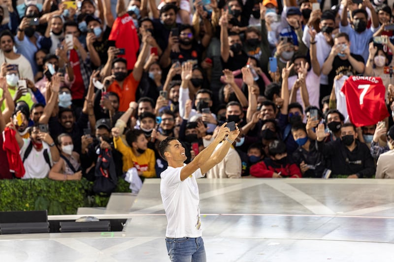 Cristiano Ronaldo takes a selfie with the crowd at the Al Wasl Plaza, Expo 2020 Dubai. Reuters