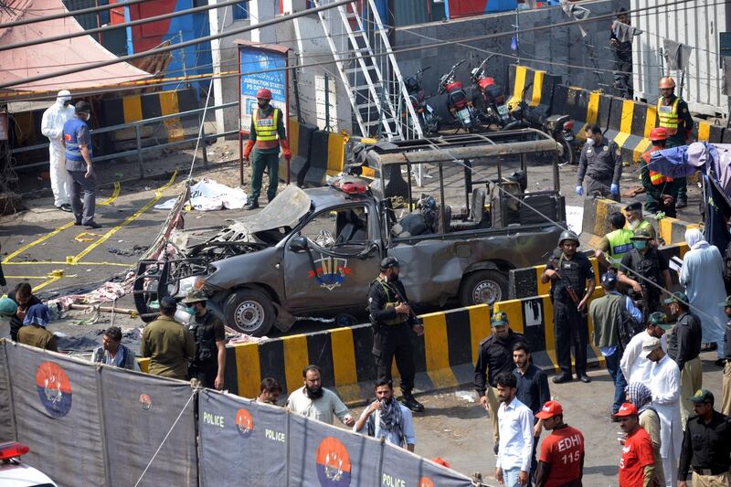 Officials examine the site of the bomb blast. EPA