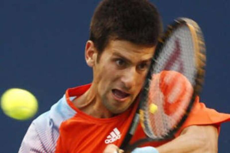 Novak Djokovic of Serbia returns a shot to Frank Dancevic of Canada at the Rogers Cup tournament in Toronto.