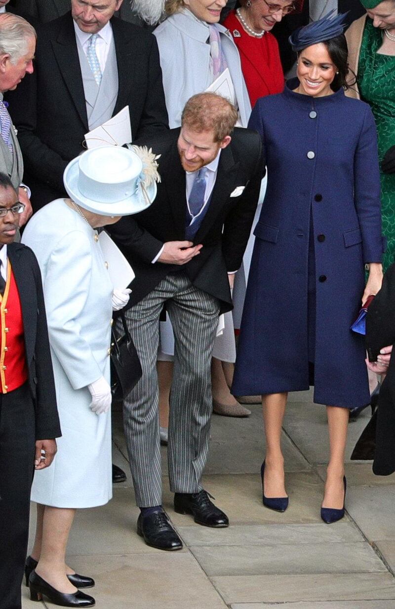 WINDSOR, ENGLAND - OCTOBER 12: Queen Elizabeth II speaks with the Duke and Duchess of Sussex outside St George's Chapel in Windsor Castle, following the wedding of Princess Eugenie to Jack Brooksbank on October 12, 2018 in Windsor, England. (Photo by Aaron Chown - WPA Pool/Getty Images)