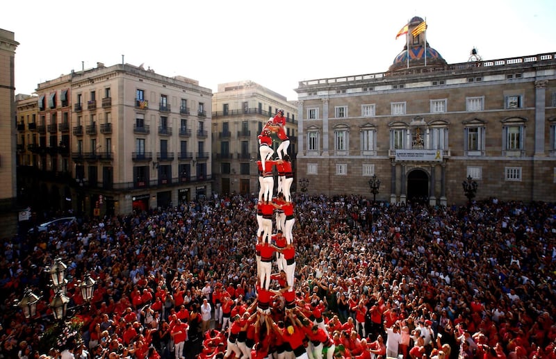 Spaniards take part in a traditional human-tower event at the Sant Jaume square in Barcelona. EPA