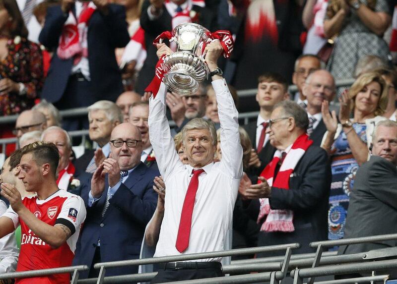 Arsene Wenger lifts the FA Cup after masterminding Arsenal's victory in the final over Chelsea. Kirsty Wigglesworth / AP Photo