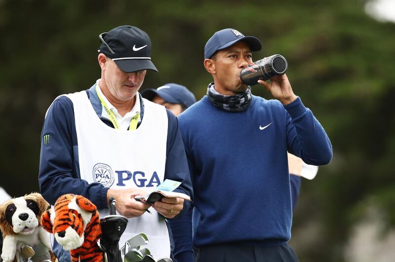 Tiger Woods talks to his caddie Joe LaCava on the 11th tee during the first round of the 2020 PGA Championship. AFP
