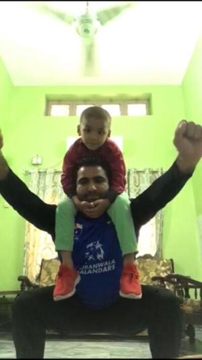 UAE spinner Sultan Ahmed performs squats with his son Abdulbakar on his shoulders as he trains during isolation. Courtesy Sultan Ahmed