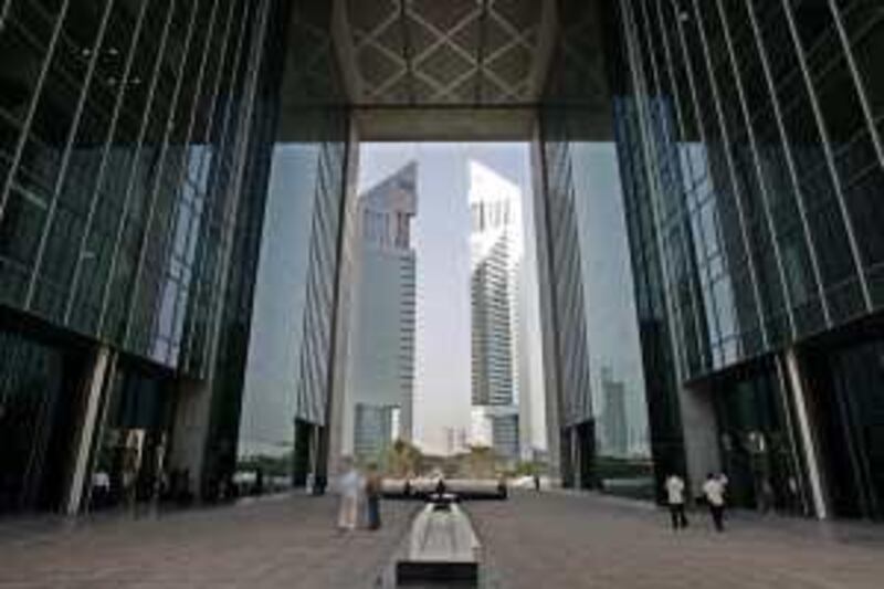 With the Emirates Towers in background, people arrive at the Gate, located at the Dubai International Financial Center, DIFC,  in Dubai, United Arab Emirates, July 12, 2006. More than three dozen international financial firms have set up offices in this Gulf city's futuristic new financial district, which is governed by its own rules, has its own courts and does business in U.S. dollars. (AP Photo/Kamran Jebreili)