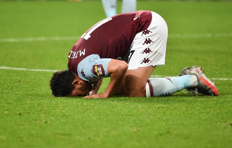 Aston Villa's Trezeguet kisses the pitch after the Premier League win over Arsenal. AP