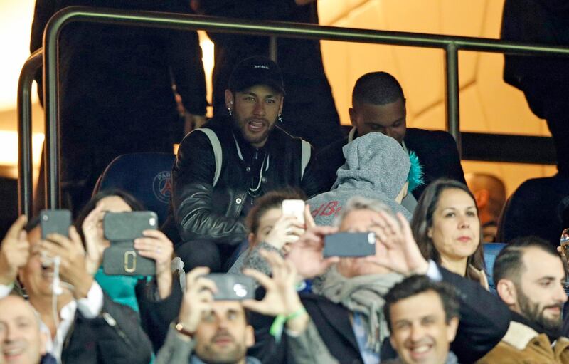 Paris Saint Germain's injured Brazilian forward Neymar watches from the stands at the Parc des Princes. EPA