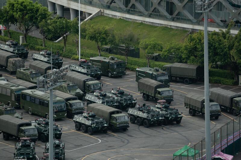 Trucks and armoured personnel carriers are seen parked at the stadium in Shenzhen, bordering Hong Kong in China's southern Guangdong province. AFP