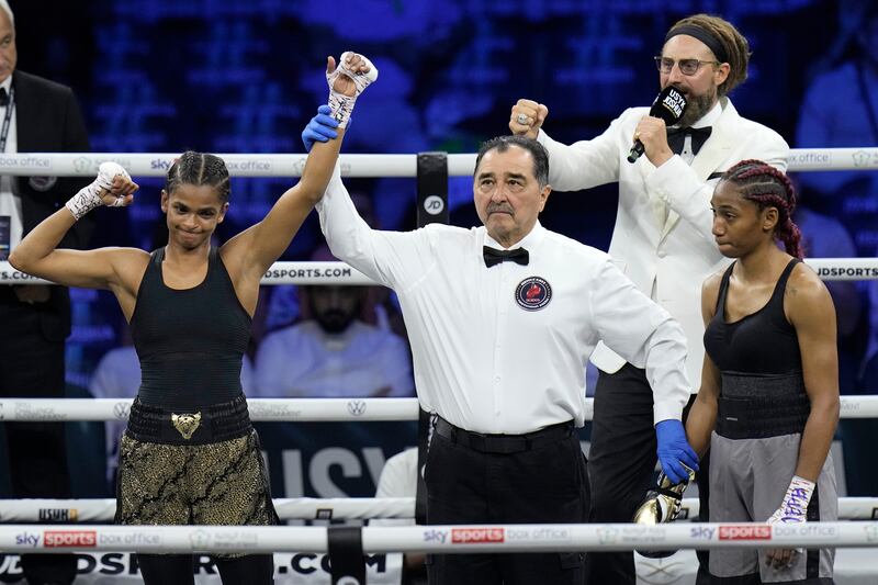 Ramla Ali, left, has her hand raised. AP