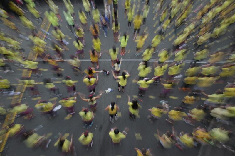 Filipinos follow steps during a Zumba class as they attempt to break a Guinness world record in suburban Mandaluyong, east of Manila, Philippines on Sunday, July 19, 2015.  Guinness representative Alan Pixley announced that Mandaluyong city in the Philippines now holds the new world record for the title largest Zumba class with a total participant of 12,975. Aaron Favila / AP photo