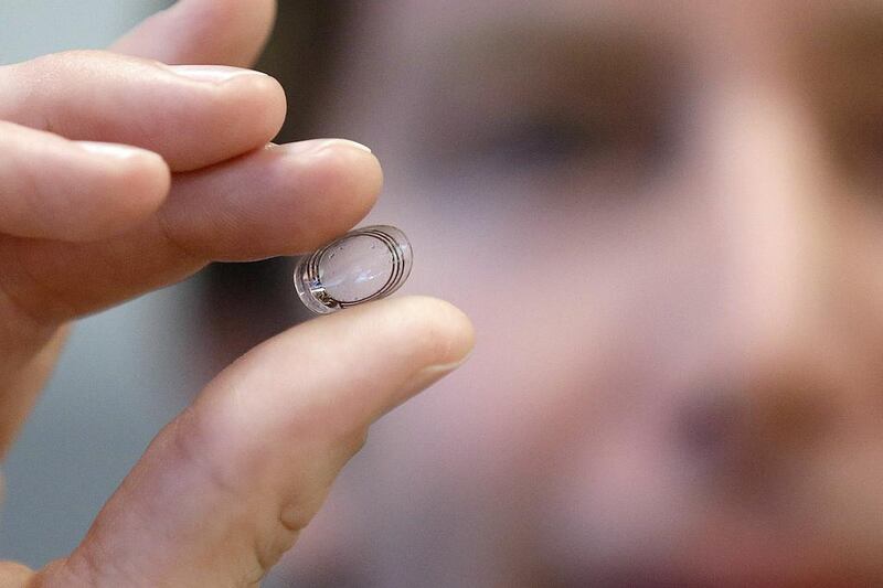 Brian Otis, the Google X project lead, holds a contact lens Google is testing in this January 2014 photo. Jeff Chiu / AP Photo
