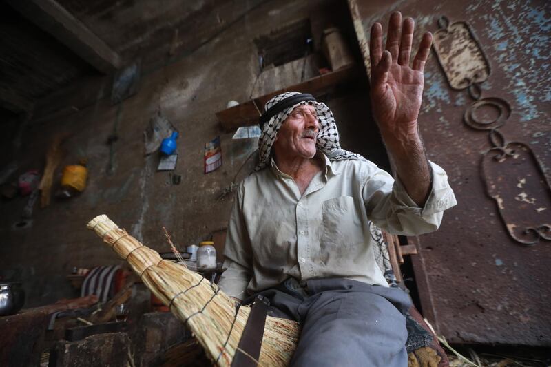 Palestinian Sabri Dwekat makes handmade brooms at his home near Nablus. EPA