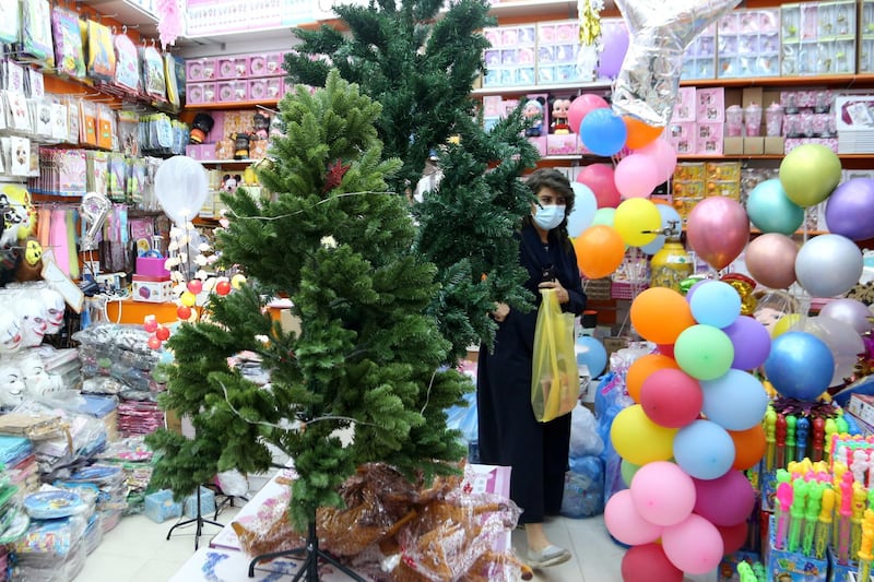 A woman buys decorations from a shop selling various items for Christmas celebrations, after the government eased restrictions on the sale of Christmas ornaments and decorations, in Riyadh, Saudi Arabia.  Reuters